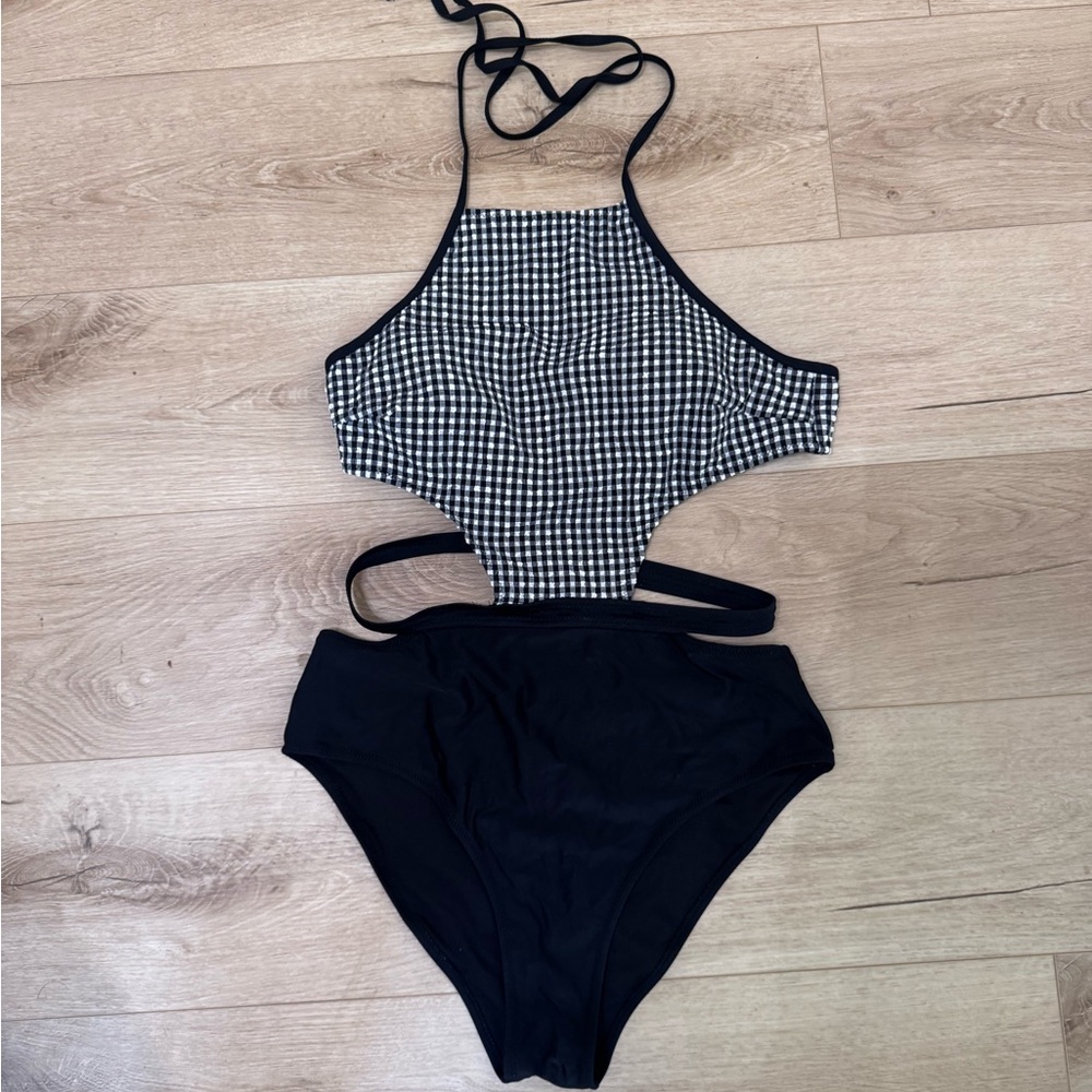 Black and white gingham one- piece bathing suit with cut out sides.